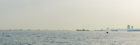 accumulation of cargo ships in the sea on the horizon during a queue waiting at the port. Panoramic view.の写真素材