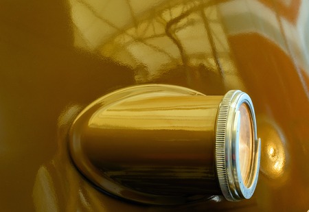 Big locomotive reflector with light bulb on the sidewall. Brown body.の写真素材