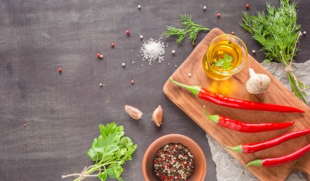 Parsley dill pepper and garlic in a dark wooden table. View from above. Space for text.の写真素材
