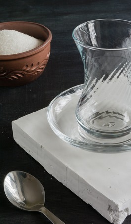 Transparent cup of thin glass and black tea. Spoon into a glass. Empty placeの写真素材