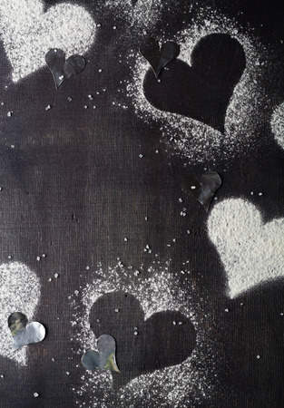 Card for Valentine's Day. Contours Hearts snow. Strict dark background.の写真素材