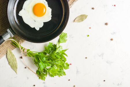 Morning in the kitchen. Cooking breakfast. Fried egg. Light background and place for text.の写真素材