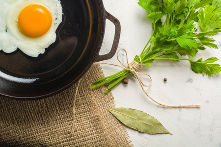 Morning in the kitchen. Cooking breakfast. Fried egg. Light background and place for text.の写真素材