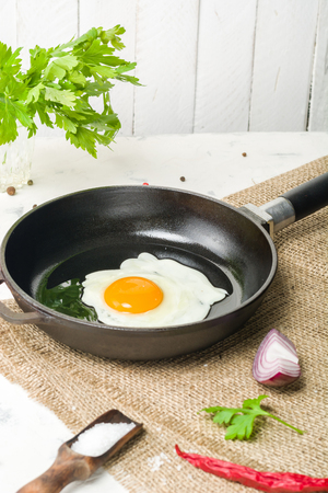 Morning in the kitchen. Cooking breakfast. Fried egg. Light background and place for text.の写真素材