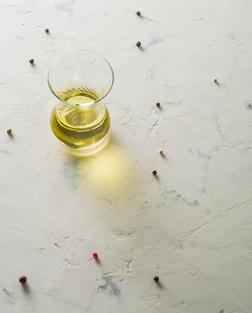 Glass cup with vegetable oil on a light background. Space for text.の写真素材