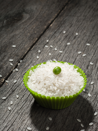 Rice on gray wooden table. Space for text.の写真素材
