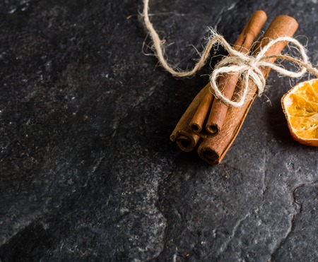 Dry slices of citrus fruits on a black slate background. Space for text.の写真素材