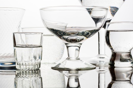 Glass shined with colored light on a light background. A high key.の写真素材