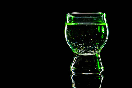 Glass shined with colored light on a black background. Low key.の写真素材