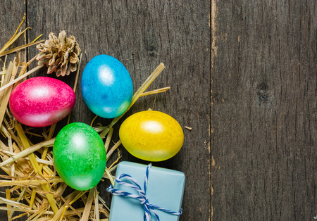 Easter background with colorful chicken eggs on old gray boards. Place for the text.の写真素材