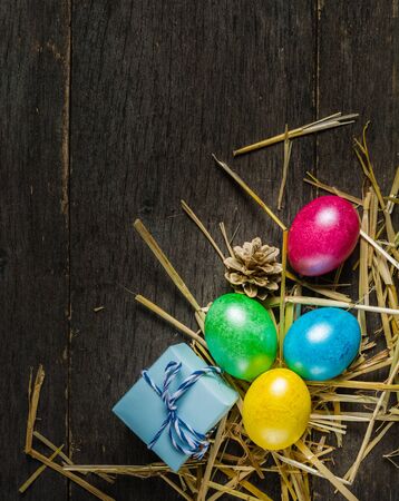 Easter background with colorful chicken eggs on old gray boards. Place for the text.の写真素材
