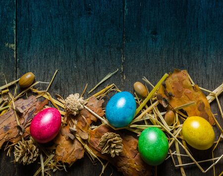 Easter background with colorful chicken eggs on old gray boards. Place for the text.の写真素材