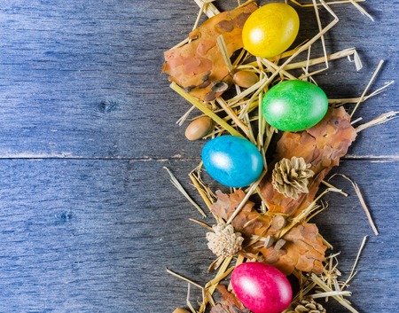 Easter background with colorful chicken eggs on old gray boards. Place for the text.の写真素材