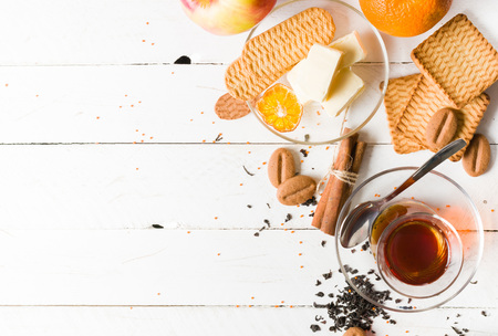 Morning tea with fruit and candied fruit. White wooden background and place for text.の写真素材