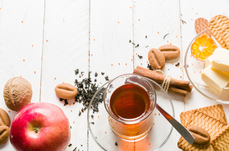 Morning tea with fruit and candied fruit. White wooden background and place for text.の写真素材