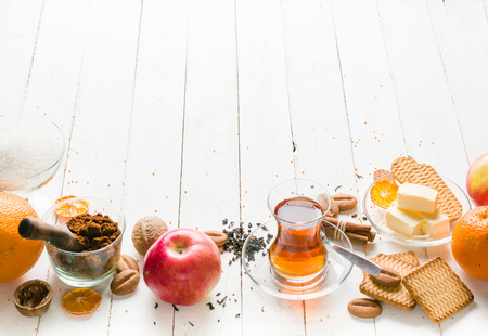 Morning tea with fruit and candied fruit. White wooden background and place for text.の写真素材