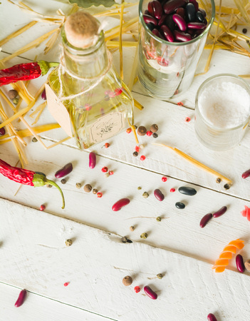 Vegetable oil in a bottle with seasonings and spices on a white wooden background. Place for the text.の写真素材