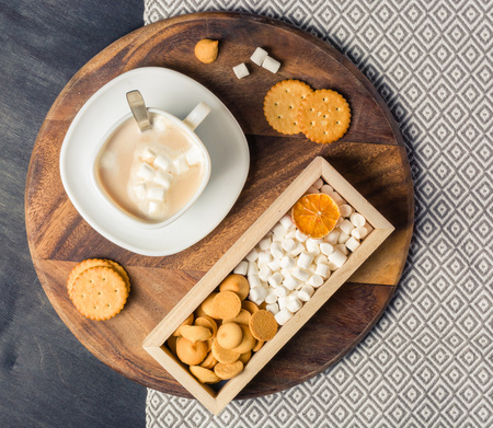 Morning cocoa with marshmallows, cookies and milk in wooden box. Dark wooden background. Place for the text.の写真素材