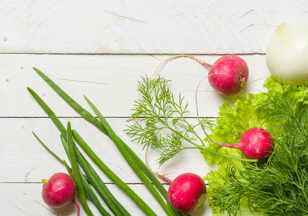 Variety of vegetables on a white wooden table together with a red checkered cloth. View from above.の写真素材