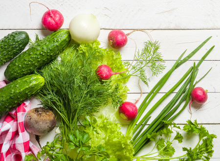 Variety of vegetables on a white wooden table together with a red checkered cloth. View from above.の写真素材