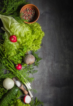 Variety of vegetables on a black wooden table. Spring still life. View from above.の写真素材
