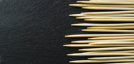 Toothpick on a black background. Not an even number. View from above.の写真素材