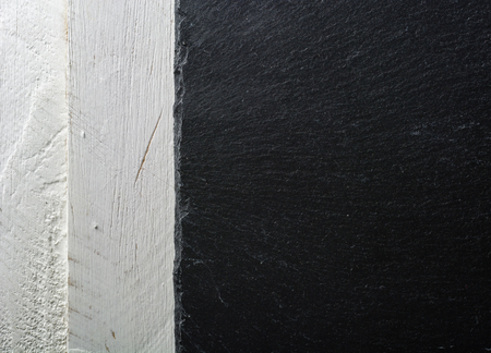 Background slate black on white painted board. View from above. Lots of space for text.の写真素材
