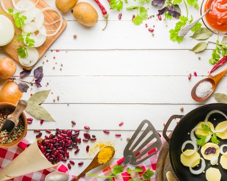 Preparation of soup at home. Rustic white background with vegetables and ingredients around the perimeter.の写真素材