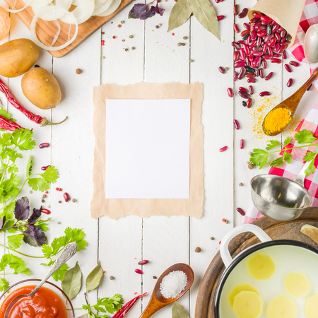 Preparation of soup at home. Rustic white background with vegetables and ingredients around the perimeter.の写真素材