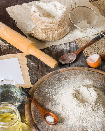 Ingredients for cooking dough or bread. Bunch of white rye flour. Dark wooden background.の写真素材