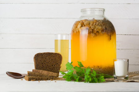 A large jar with kvass cooking. Black bread and a glass with a drink. Copy space.の写真素材