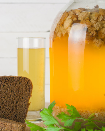A large jar with kvass cooking. Black bread and a glass with a drink. Copy space.の写真素材