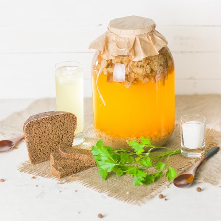 A large jar with kvass cooking. Black bread and a glass with a drink. Copy space.の写真素材
