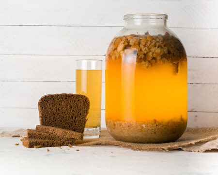 A large jar with kvass cooking. Black bread and a glass with a drink. Copy space.の写真素材