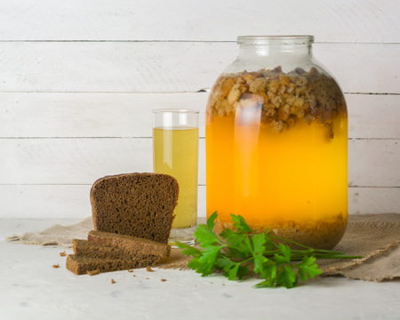 A large jar with kvass cooking. Black bread and a glass with a drink. Copy space.の写真素材