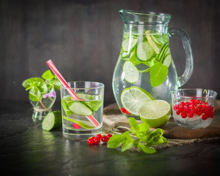 Water detox in a glass jar and a glass. Fresh green mint and berries. A refreshing and healthy drink. Copy space.の写真素材