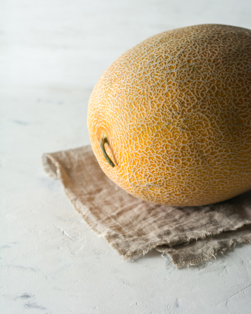 Ripe yellow melon on a light background. High key.の写真素材