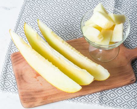 Ripe big and yellow melon. Cut into pieces. Appetizing background. Healthy food.の写真素材