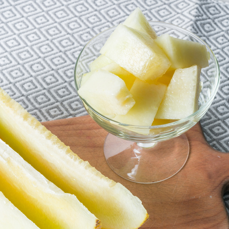 Ripe big and yellow melon. Cut into pieces. Appetizing background. Healthy food.の写真素材