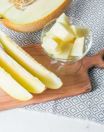 Ripe big and yellow melon. Cut into pieces. Appetizing background. Healthy food.