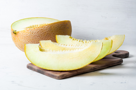Ripe big and yellow melon. Cut into pieces. Appetizing background. Healthy food.の写真素材