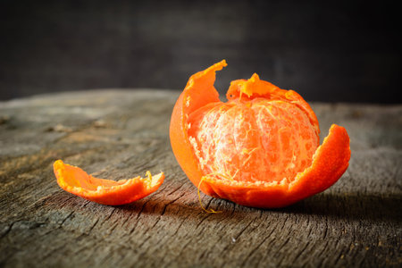 A mandarins on a wooden background. The cleared fruit.