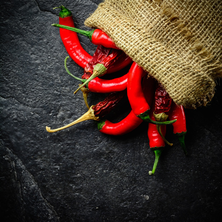 Hot and fresh red pepper in a bag. Dark stone background from slate.の写真素材