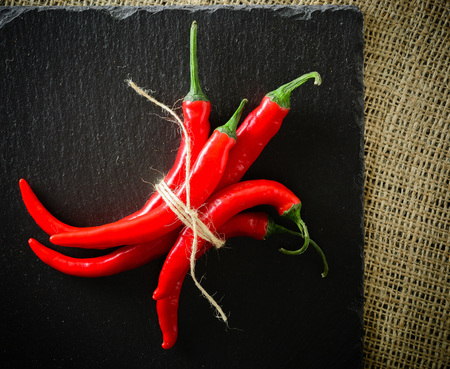 A composition of chili pepper. Dark stone background from slate. Copy space.の写真素材
