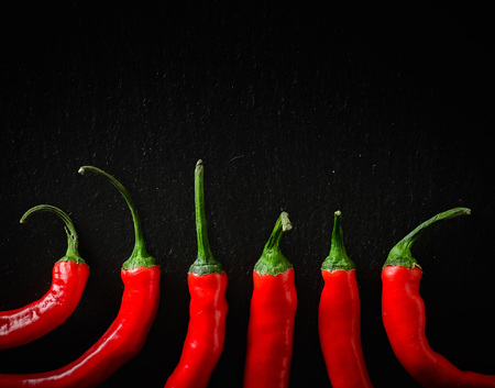 A composition of chili pepper. Dark stone background from slate. Copy space.の写真素材