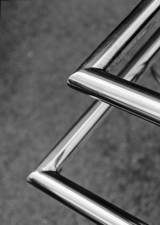 Polished stainless pipes welded at an angle. Gray industrial background.の写真素材