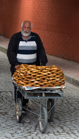 ISTANBUL-MAY 20: A old man sells sesame bagels on a cart May 20, 2015 Istanbul, Turkey