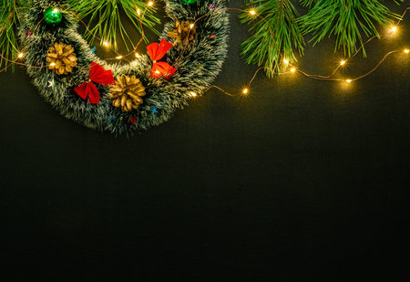 Dark magic background card for Christmas or New Year. Bright blurry lights of a garland. Place for greeting textの写真素材