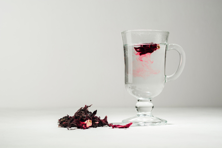 Transparent glass Cup with hot red tea from hibiscus or hibiscus. Copy space.の写真素材
