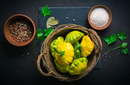 Yellow and green squash lying on a dark kitchen table. Seasonings and spices for cookingの写真素材